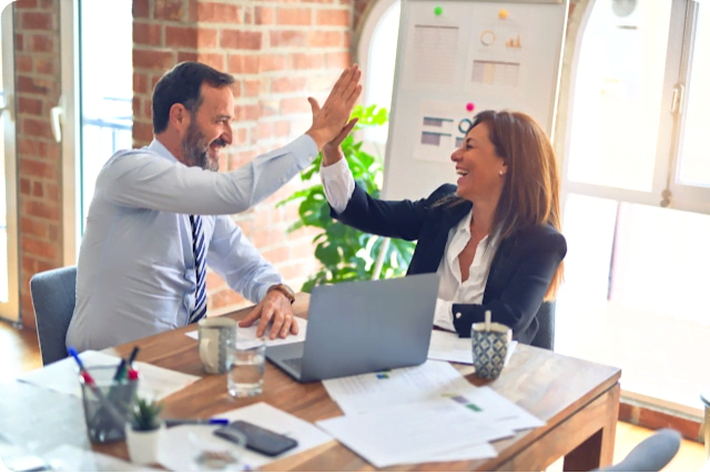 Two business people celebrating success